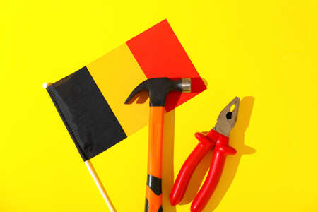 Flag of Belgium and tools on color background. labor day celebrationの写真素材