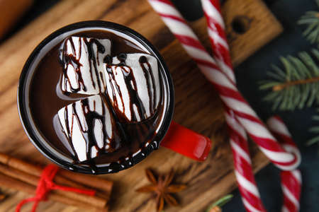 Mug of tasty hot chocolate on wooden table