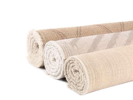 Different rolled carpets isolated on whiteの写真素材