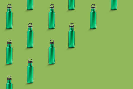 Many bottles for water on green background with space for textの写真素材