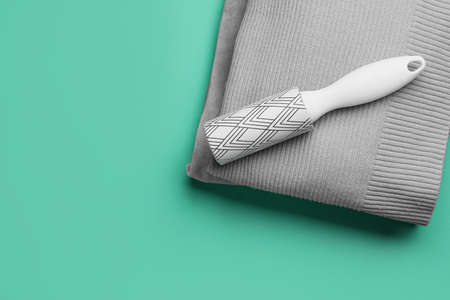 Lint roller with clothes on blue backgroundの写真素材