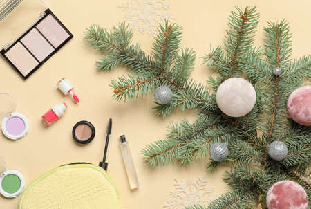 Makeup cosmetics with Christmas decor on beige backgroundの写真素材