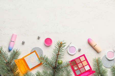 Makeup cosmetics with Christmas decor on white backgroundの写真素材