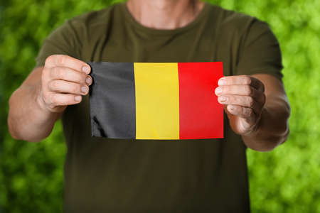 Man with Belgian flag on color background, closeupの写真素材