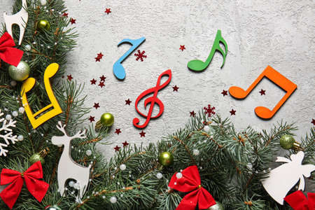 Christmas decor, fir branches and note signs on light background, closeupの写真素材