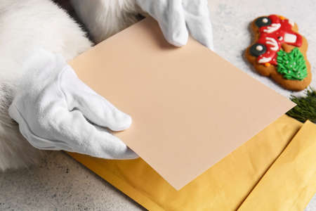 Santa Claus reading wish list letter on light table