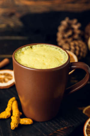 Cup of delicious turmeric latte on table, closeupの写真素材