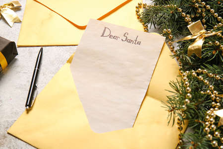 Christmas decor, envelope and letter with text DEAR SANTA on light table, closeupの写真素材