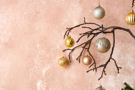 Tree branches with Christmas balls near pink wall, closeupの写真素材
