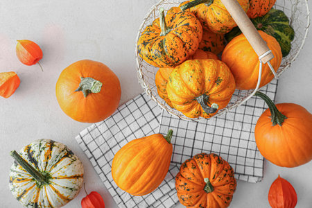 Basket with different pumpkins and physalis on light background, closeupの写真素材