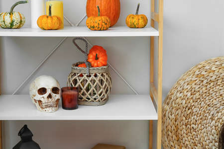 Decor for Halloween party on rack in roomの写真素材