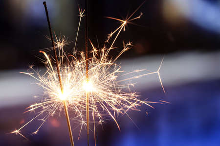 Burning sparklers at night cityの写真素材