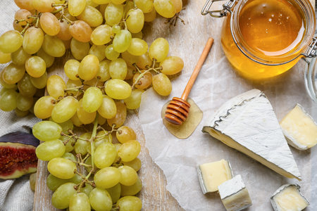 Composition with ripe grapes, cheese and honey, closeupの写真素材