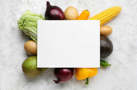 Fresh vegetables and blank sheet of paper on light background. Vegan Dayの写真素材