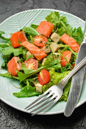Plate with fresh salad on dark background, closeupの写真素材