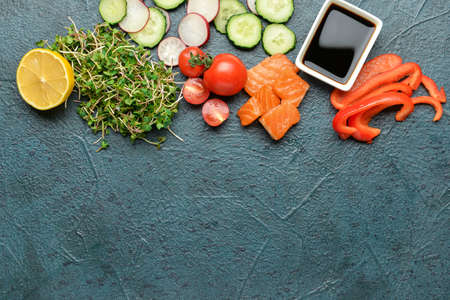 Ingredients for preparing tasty poke bowl on dark backgroundの写真素材