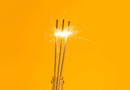 Bottle with Christmas sparklers on color backgroundの写真素材