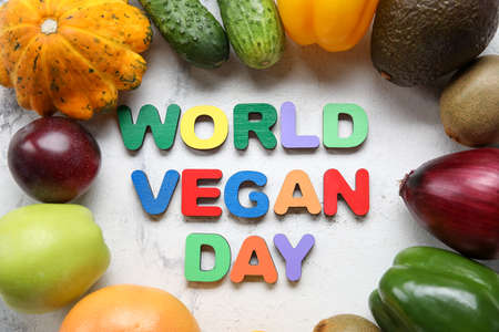 Text WORLD VEGAN DAY made of colorful letters, ripe fruits and vegetables on light background, closeupの写真素材