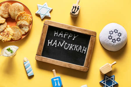 Chalkboard with text HAPPY HANUKKAH and different symbols on color backgroundの写真素材