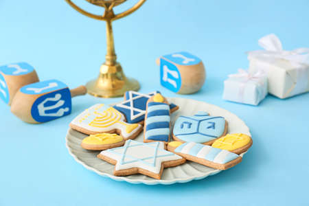 Plate with tasty cookies for Hanukkah celebration on color backgroundの写真素材