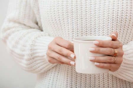Woman holding cup of coffee, closeupの写真素材