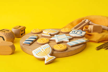 Board with tasty cookies for Hanukkah celebration on color backgroundの写真素材