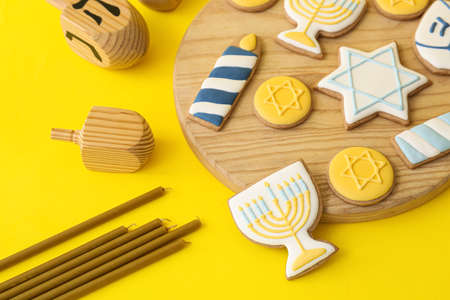 Board with tasty cookies for Hanukkah celebration on color backgroundの写真素材