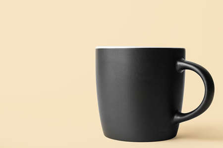 Black ceramic cup on color backgroundの写真素材