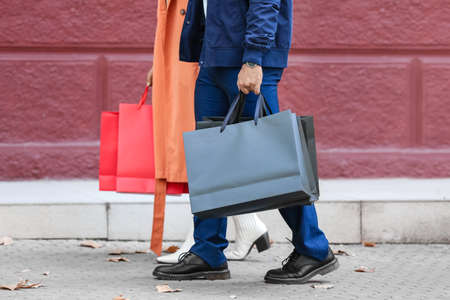 Couple with shopping bags on city streetの写真素材