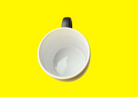 Ceramic cup on yellow backgroundの写真素材