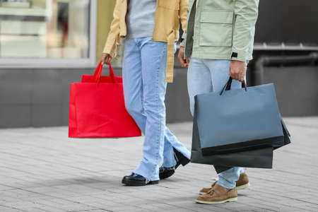 Couple with shopping bags on city streetの写真素材