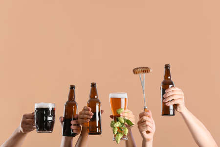 Hands with beer and snack on color backgroundの写真素材