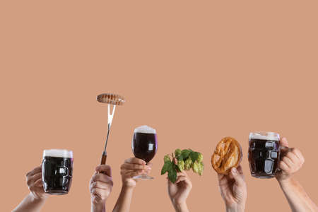 Hands with beer and snacks on color backgroundの写真素材