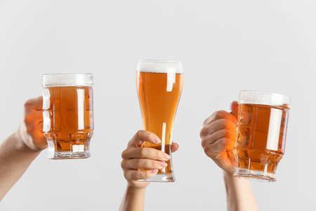 Hands with beer on gray backgroundの写真素材