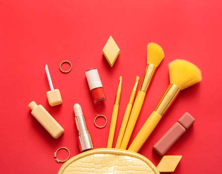 Bag with decorative cosmetics on red backgroundの写真素材