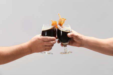 Hands with glasses of beer on gray backgroundの写真素材