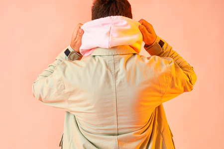 Handsome man in stylish jacket on beige backgroundの写真素材