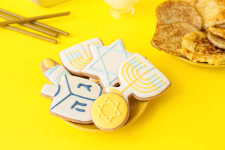 Tasty cookies for Hanukkah celebration on color backgroundの写真素材