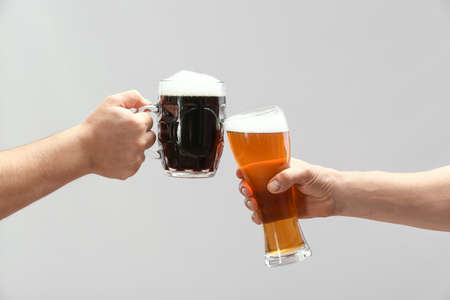 Hands with beer on gray backgroundの写真素材