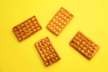 Delicious Belgian waffles on yellow backgroundの写真素材