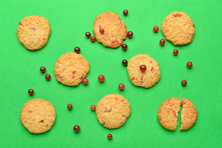 Delicious cranberry cookies and berries on green backgroundの写真素材