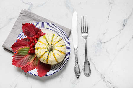 Stylish table setting and autumn decor on light marble backgroundの写真素材
