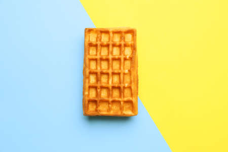Yummy Belgian waffle on color backgroundの写真素材