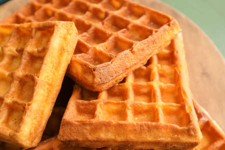 Delicious Belgian waffles on table, closeup