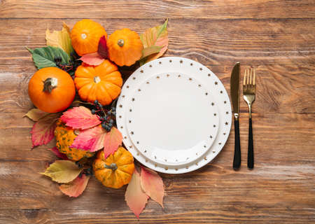 Stylish table setting and autumn decor on wooden backgroundの写真素材