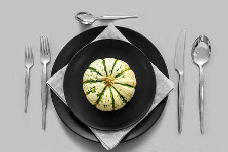 Thanksgiving table setting with pumpkin on gray backgroundの写真素材