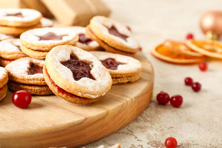 Board with tasty Linzer cookies on grunge background, closeupの写真素材