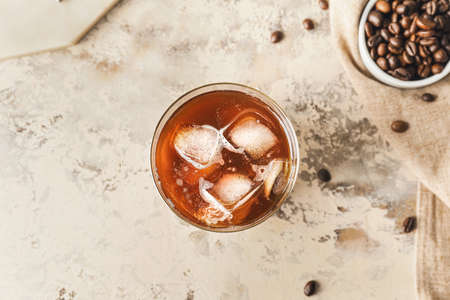 Delicious cold brew coffee with milk in glass on grunge tableの写真素材