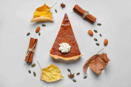 Composition with piece of tasty pumpkin pie on gray backgroundの写真素材