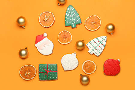 Beautiful Christmas cookies and decor on color backgroundの写真素材